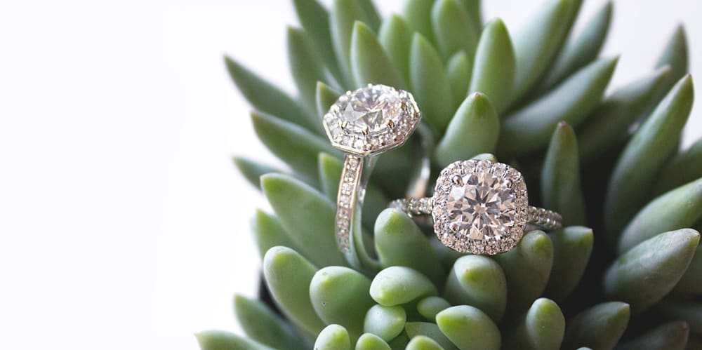 Two halo engagement rings set with Nexus Diamond™ alternatives.