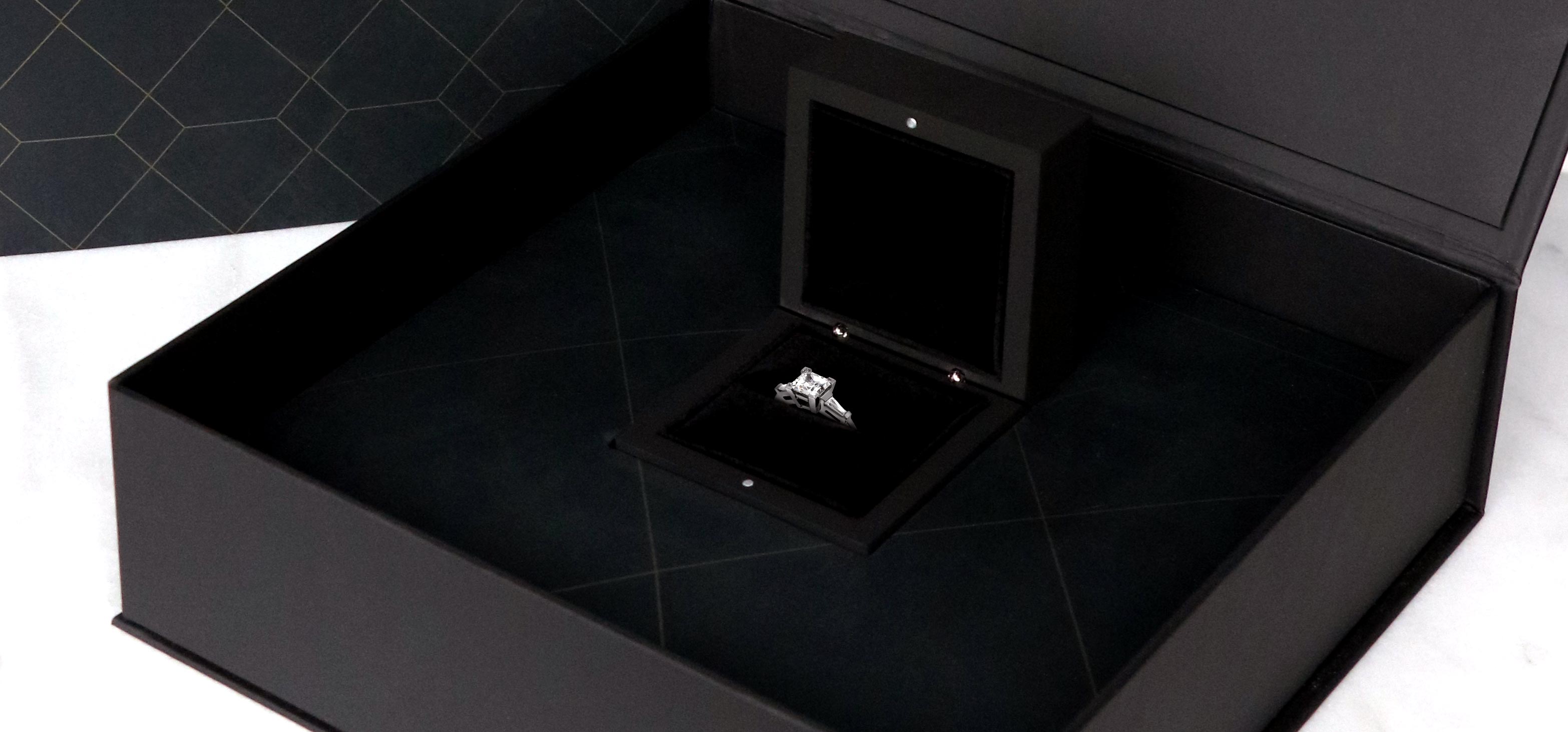 Diamond Nexus engagement ring shown in black, luxury packaging