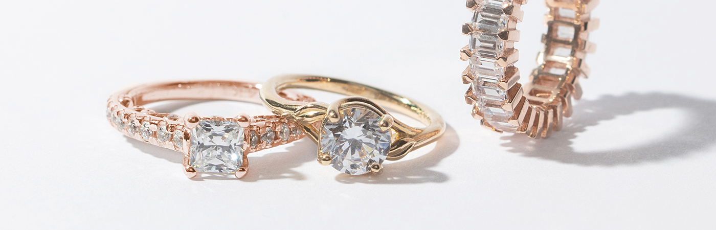 Three Diamond Nexus engagement rings in yellow and rose gold.
