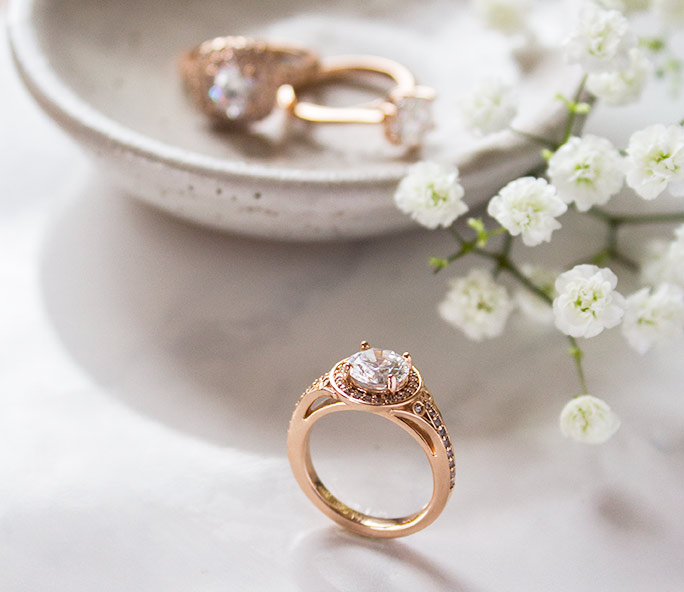 A rose gold halo engagement ring from Diamond Nexus.