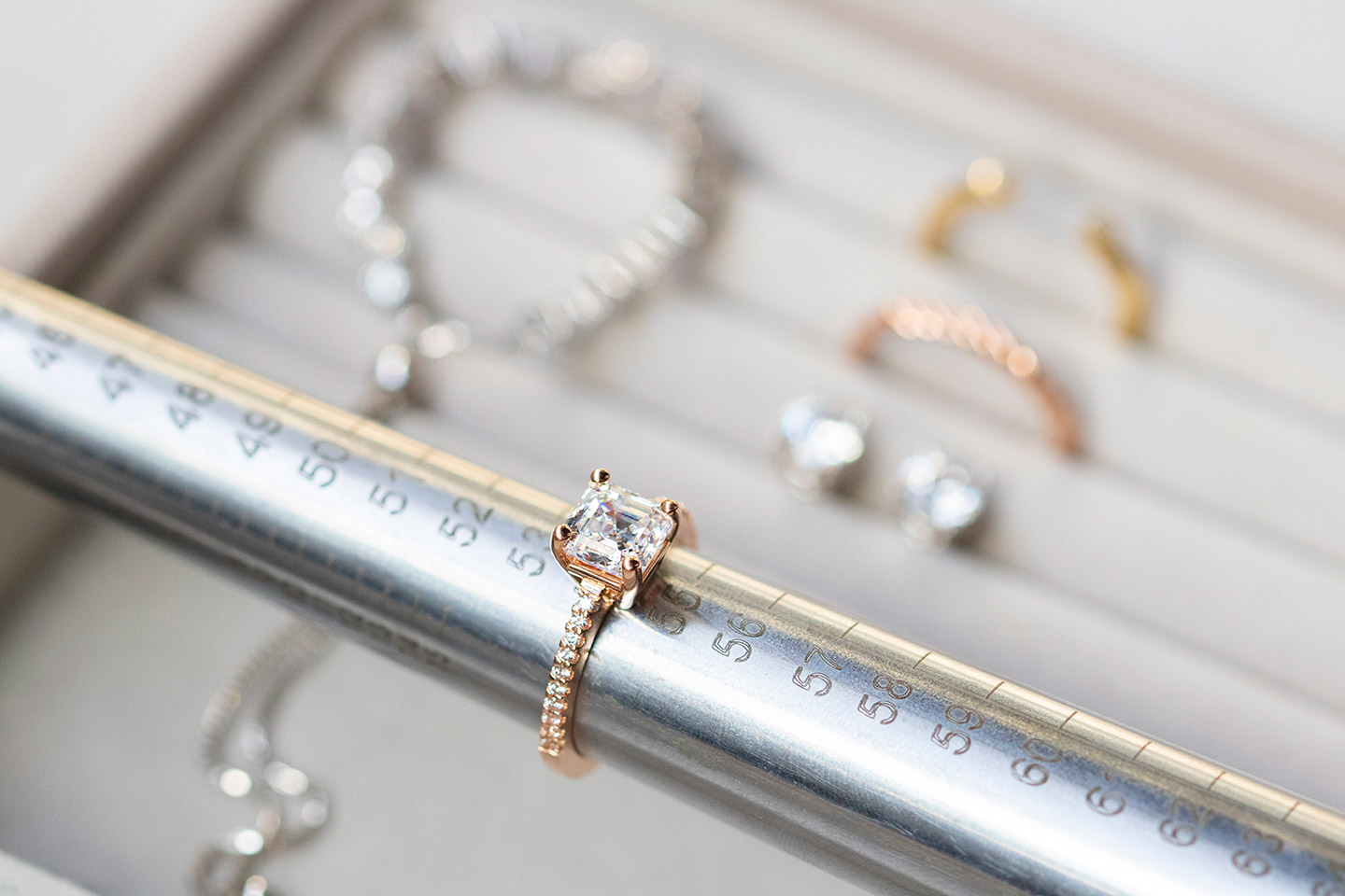 A Diamond Nexus engagement ring being measured with a mandrel. 