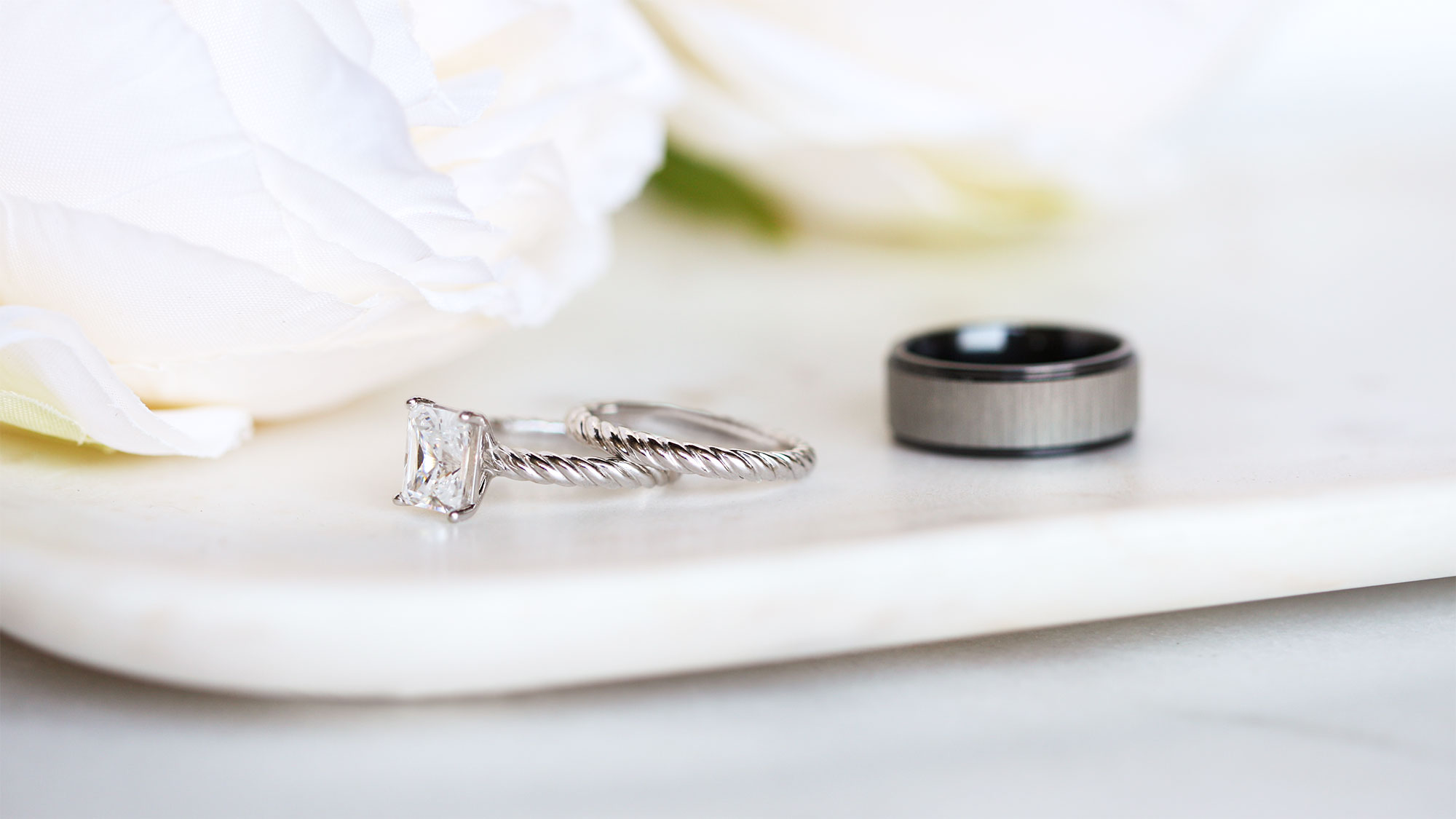 The women's Fiji wedding ring set and men's Levi wedding band.