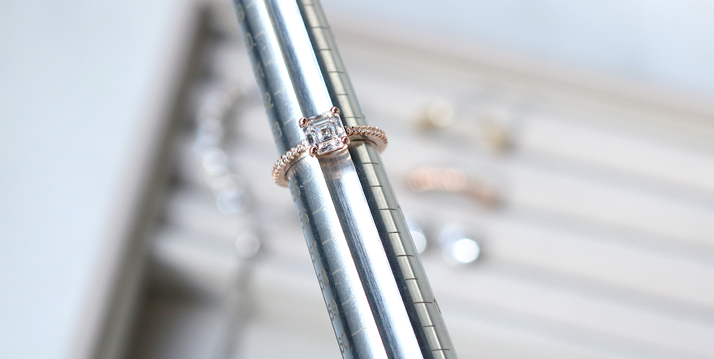 A Diamond Nexus engagement ring being measured with a mandrel.