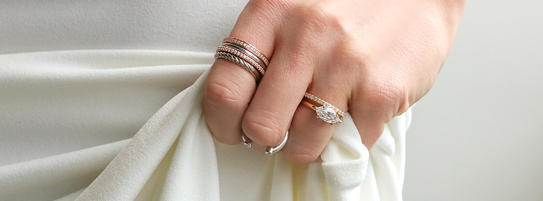stacked rings on index finger and engagement ring and wedding band on wedding finger