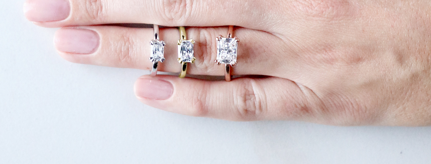 Three solitaire Nexus Diamond engagement rings featuring Radiant cut Nexus Diamond alternatives