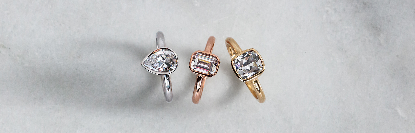 Three solitaire engagement rings in yellow, white and rose gold from Diamond Nexus