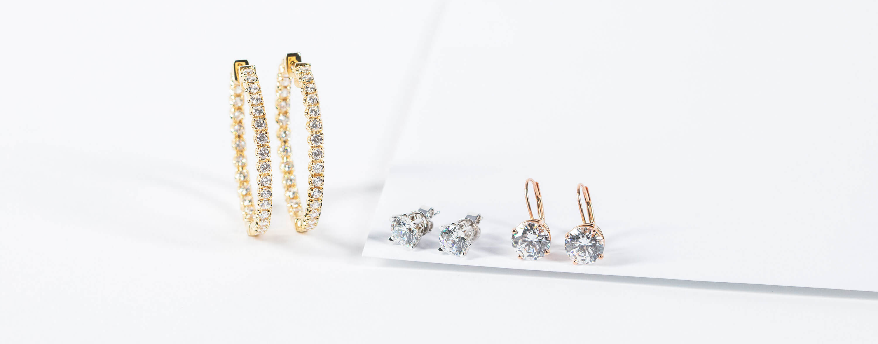 Assorted Diamond Nexus earrings in white, yellow and rose gold.