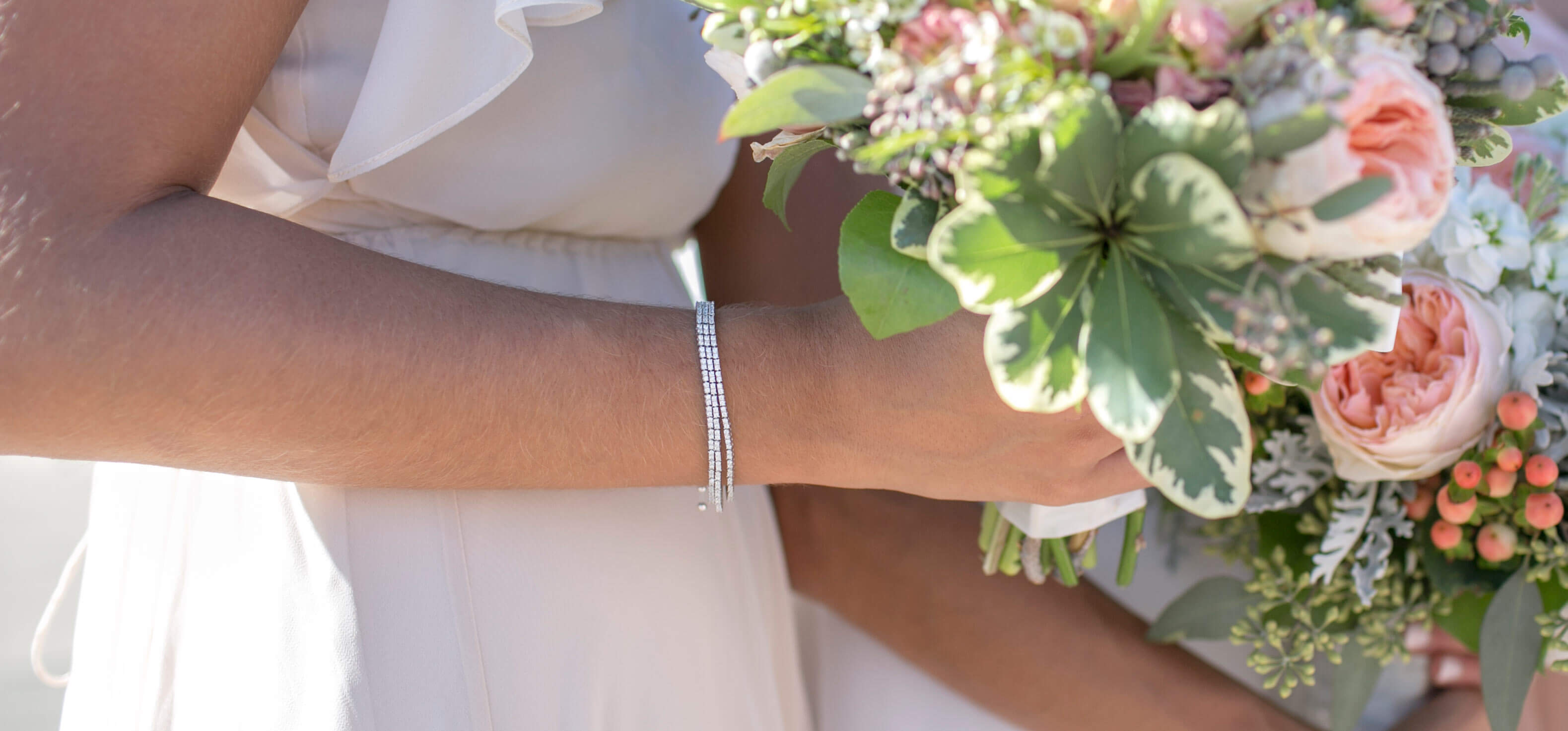 A bridesmaid wearing a Diamond Nexus bracelet stack.
