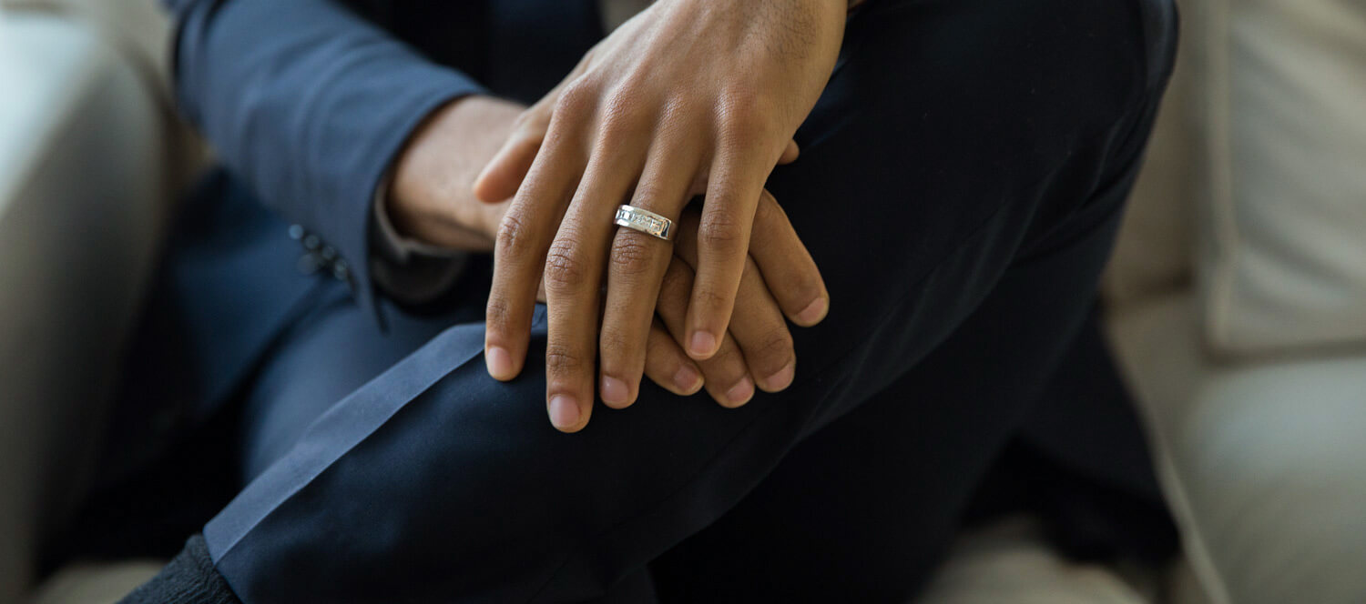 Man wearing an accented wedding band.