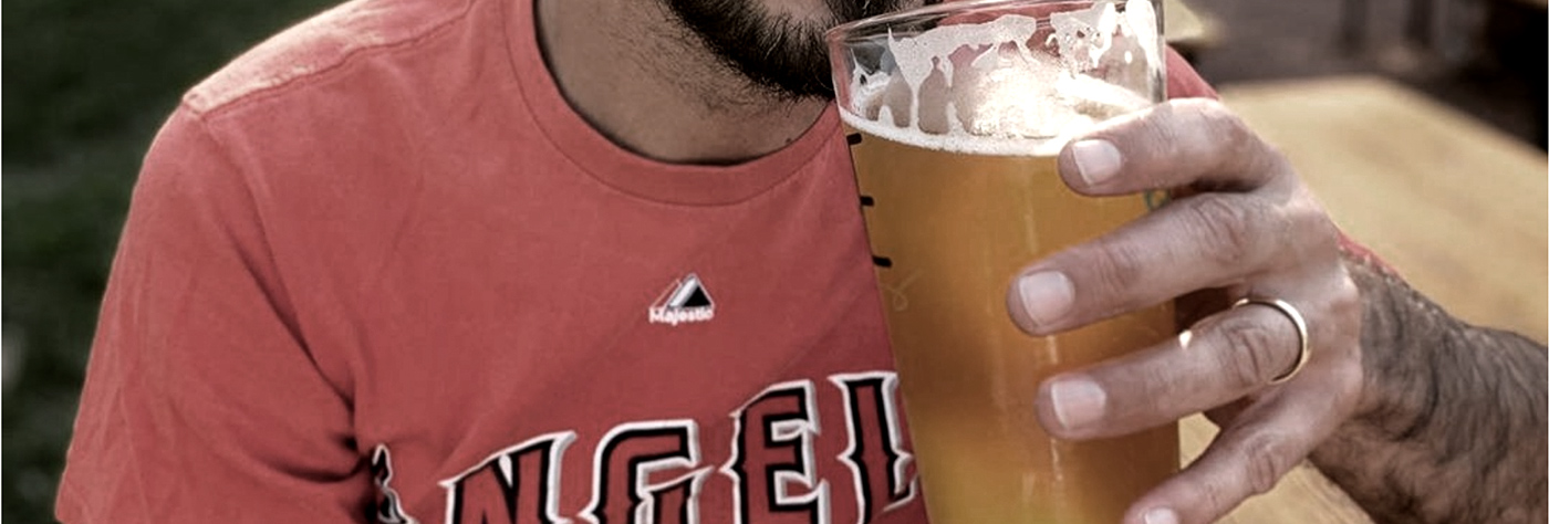 man wearing engagement ring and drinking beer