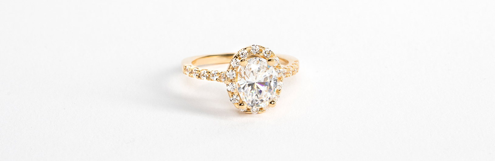 A classic oval cut simulated diamond in an accented setting