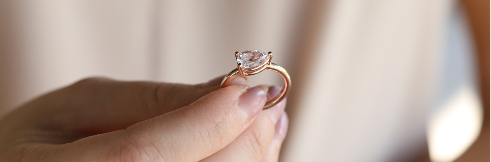 An emerald cut engagement ring in a three stone setting