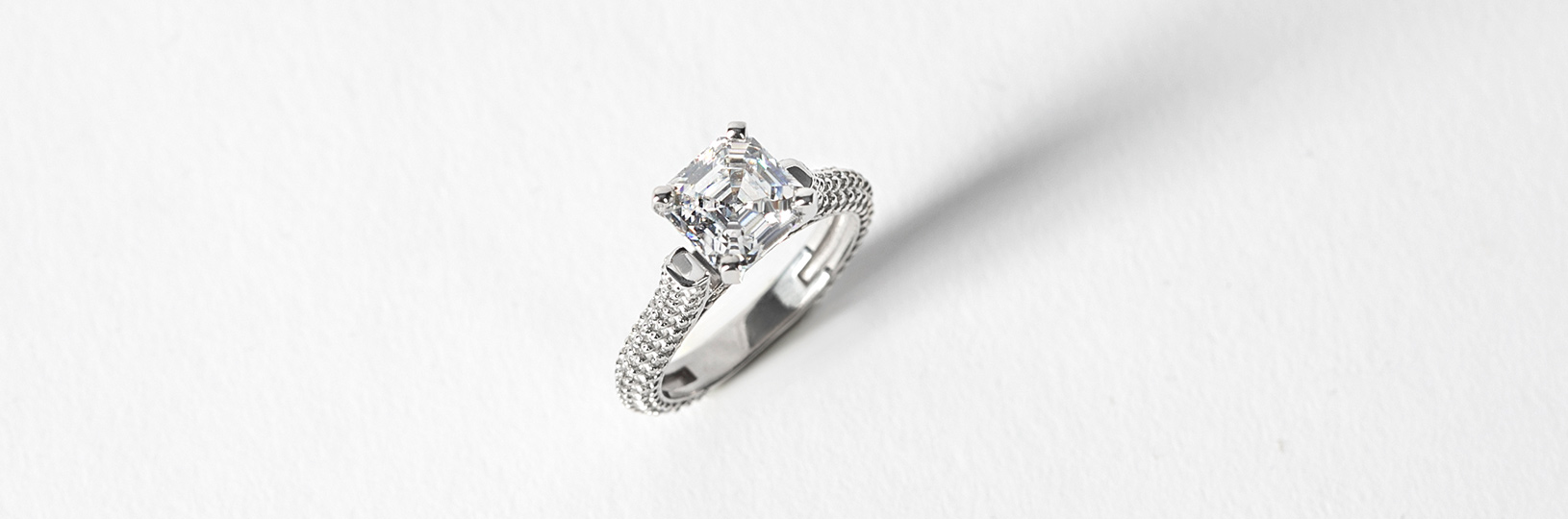 A sliver engagement ring in an accented setting