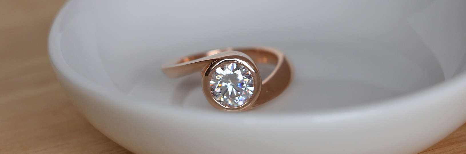 An engagement ring with a bezel setting