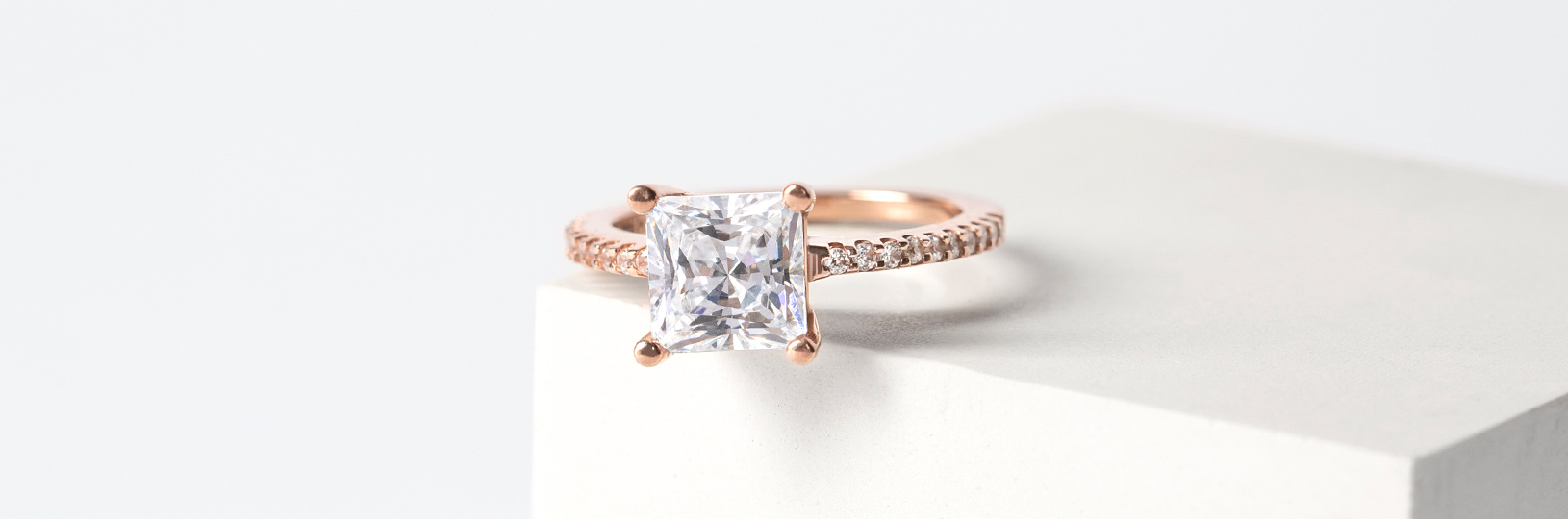 A rose gold engagement ring with an accented band
