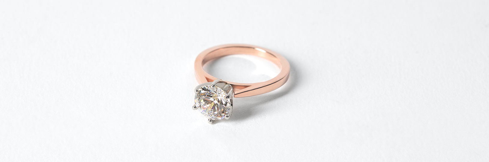 A solitaire rose gold engagement ring