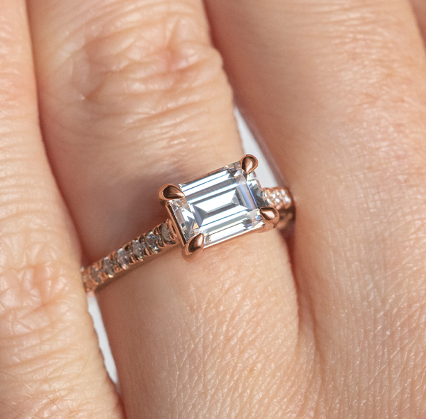 An engagement ring with statement prongs and an emerald cut stone