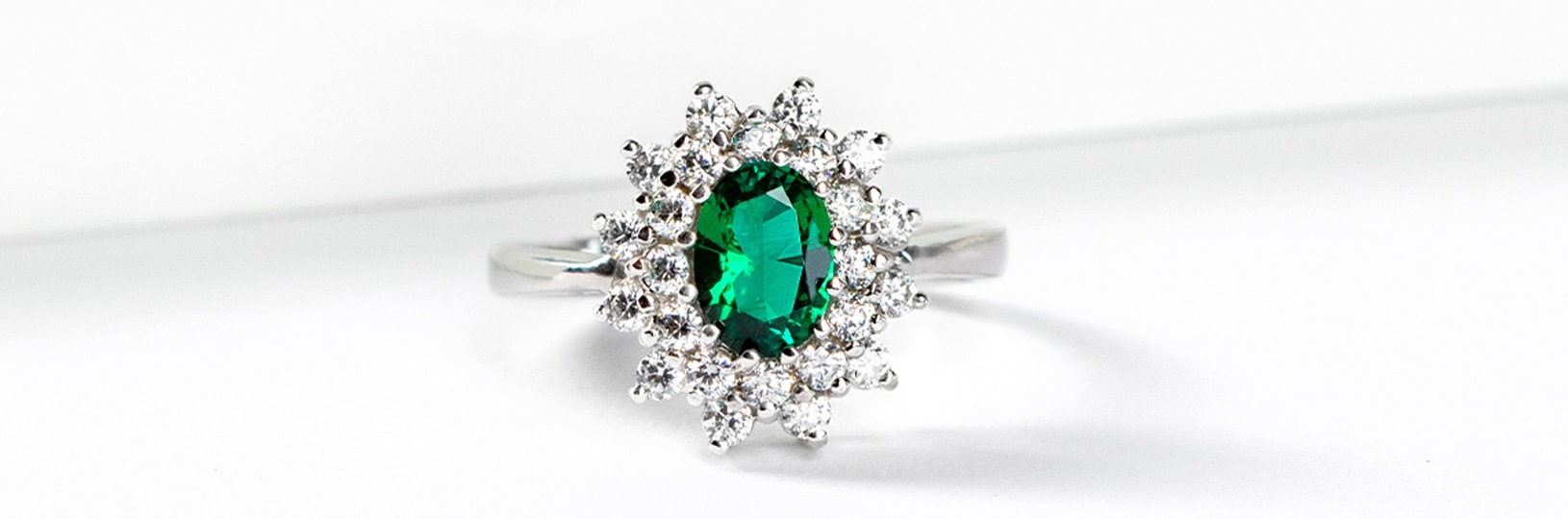 An emerald stone in a halo setting