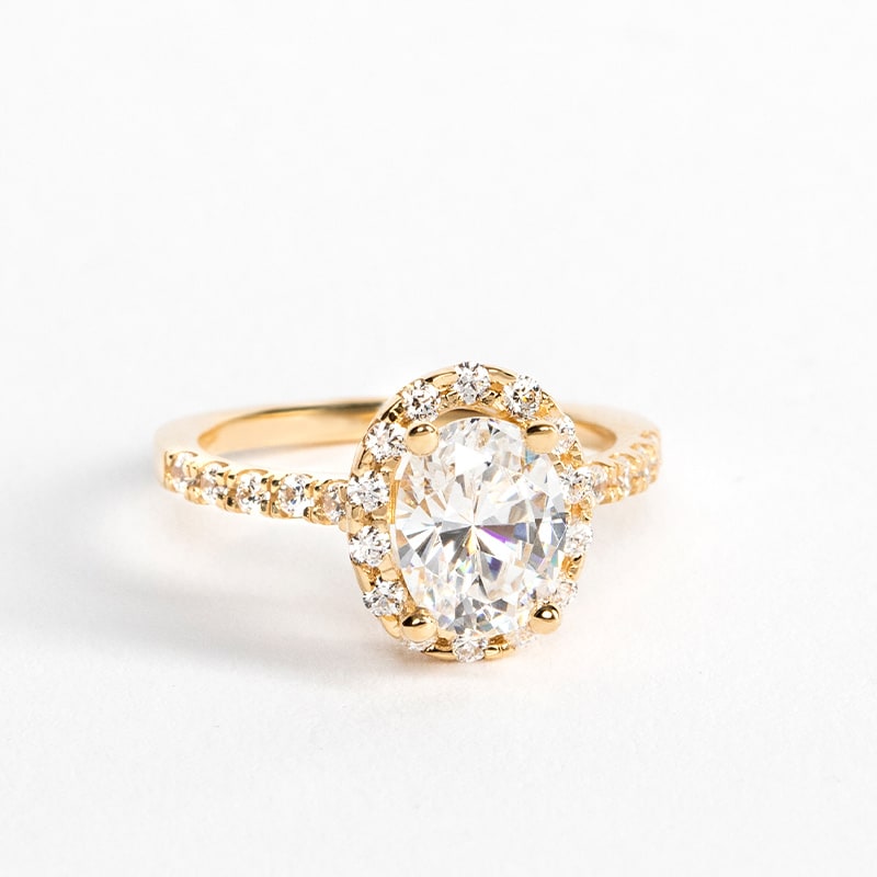 A yellow gold halo engagement ring