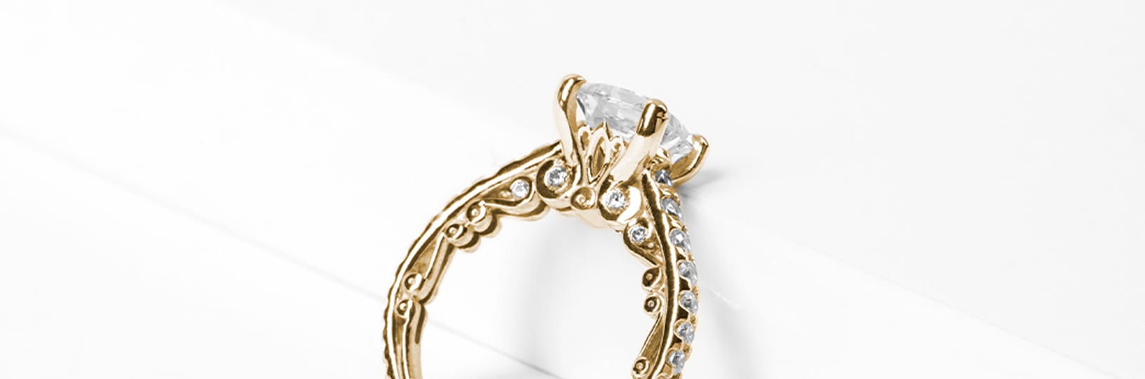 A yellow gold engagement ring with filigree