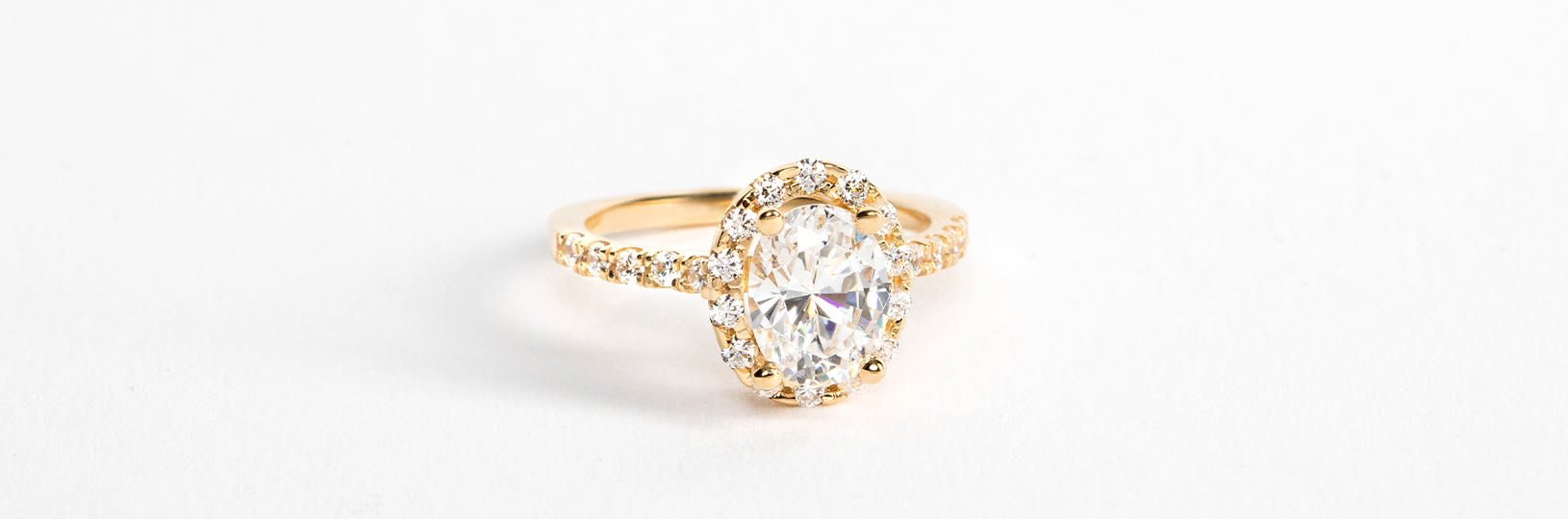 A halo engagement ring in a yellow gold setting