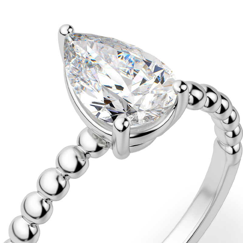 A pear cut ring with a beaded band