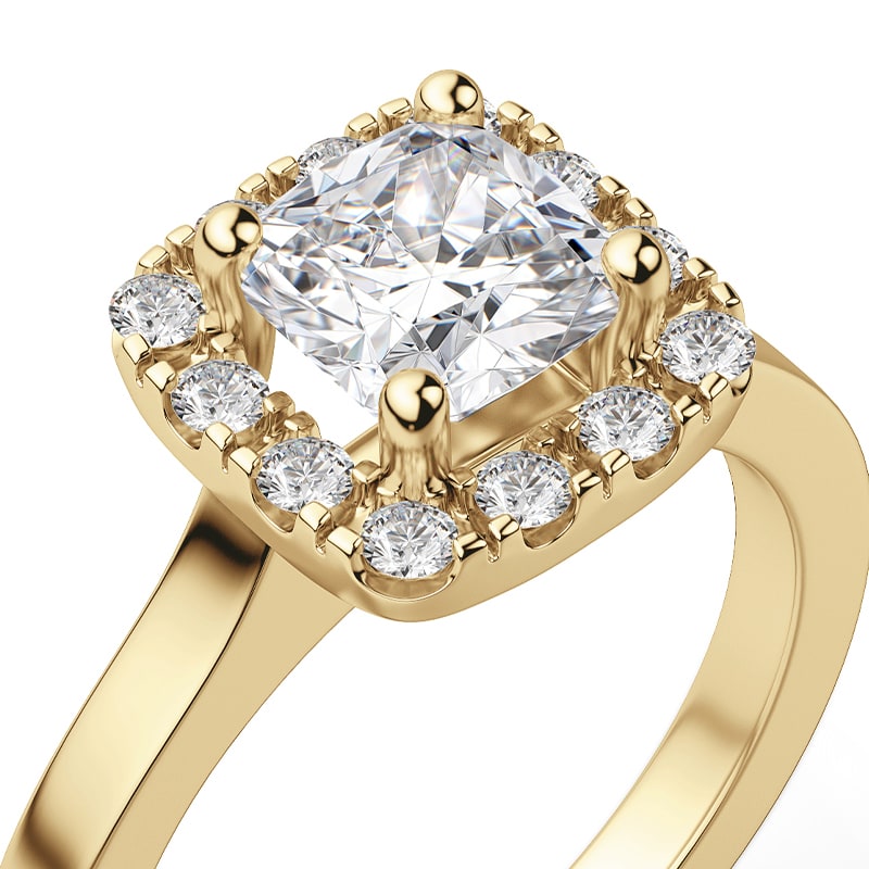 A yellow gold ring in a halo setting