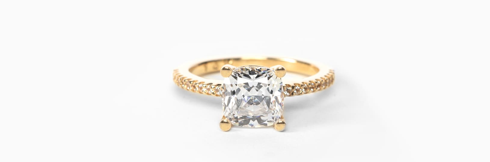 Sparkling clean yellow gold accented cushion cut ring