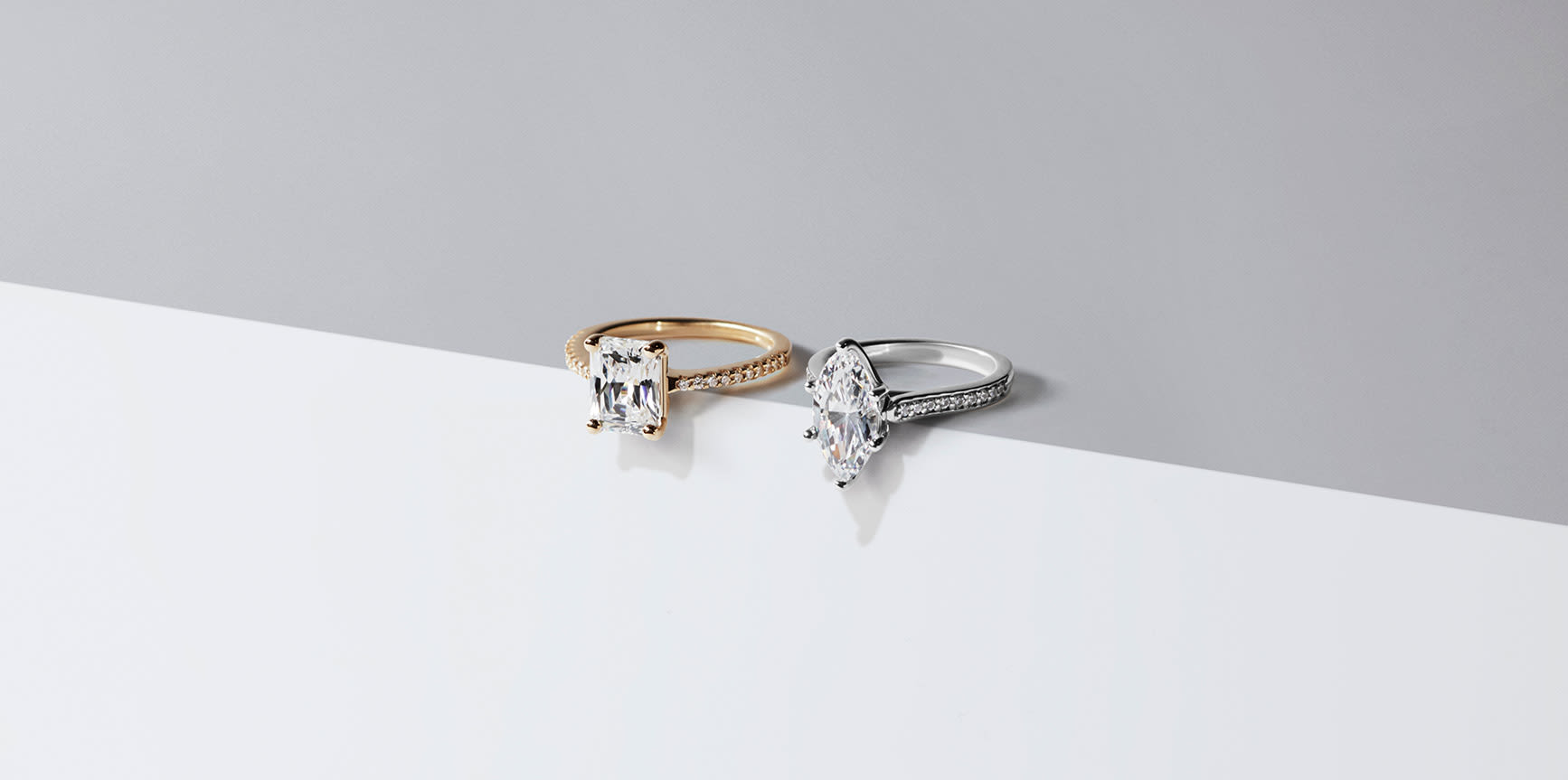Two accented solitaire engagement rings set with Nexus Diamond™ alternatives.
