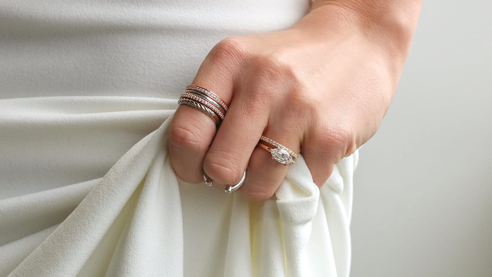 A bride wearing a mixed-metal ring stack from Diamond Nexus.