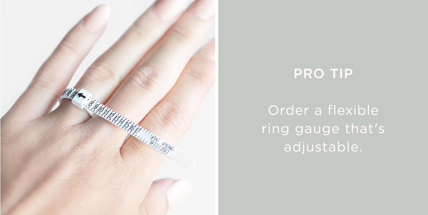 A flexible ring gauge placed on a finger to measure size.
