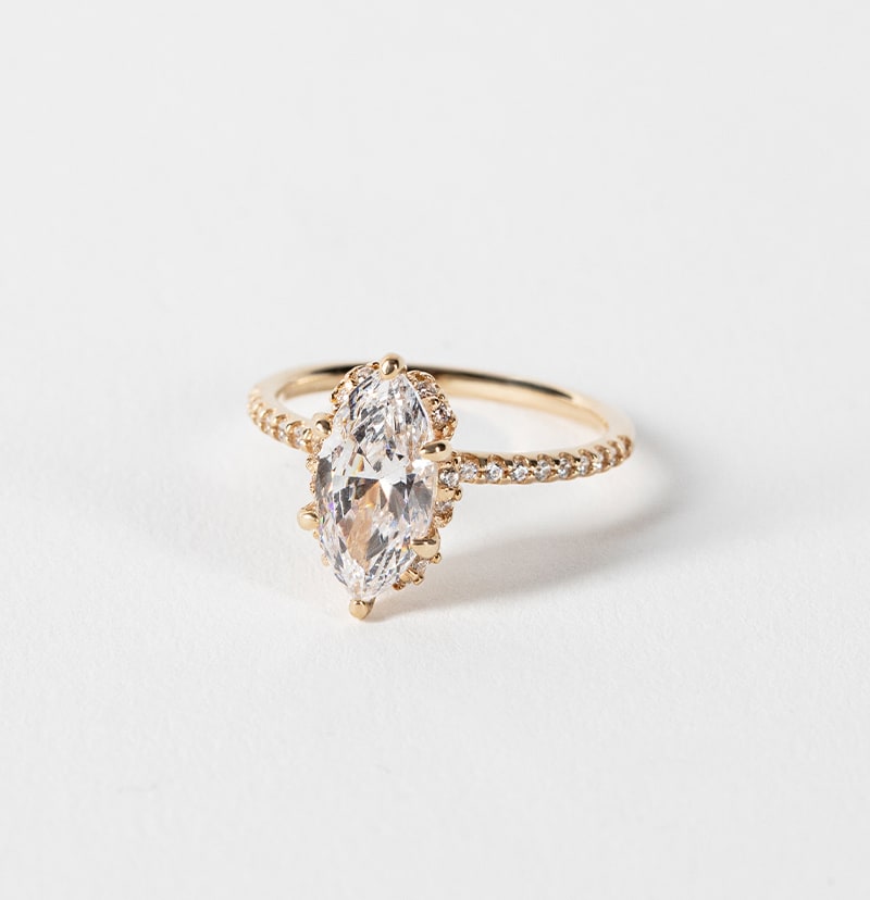 An accented marquise cut engagement ring