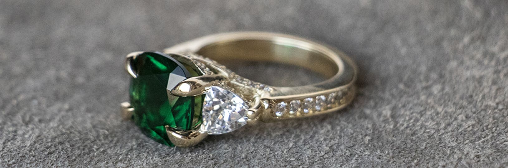 A three stone vintage engagement ring with an accented band
